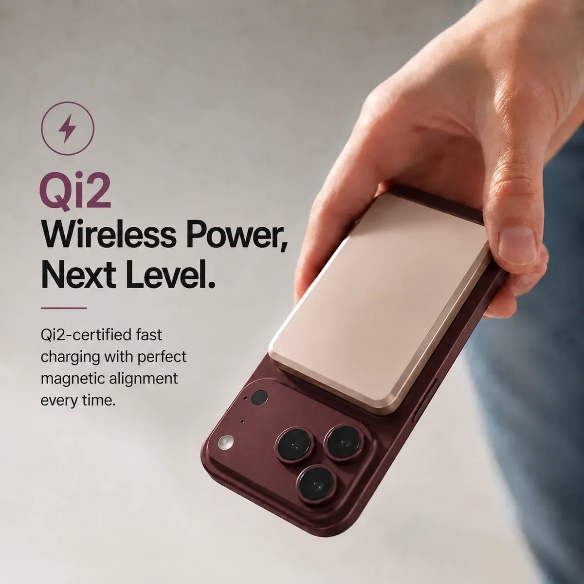 Titanium Stone Gray slim magnetic power bank attaching magnetically to a Burgundy phone. #color_Titanium Stone Gray