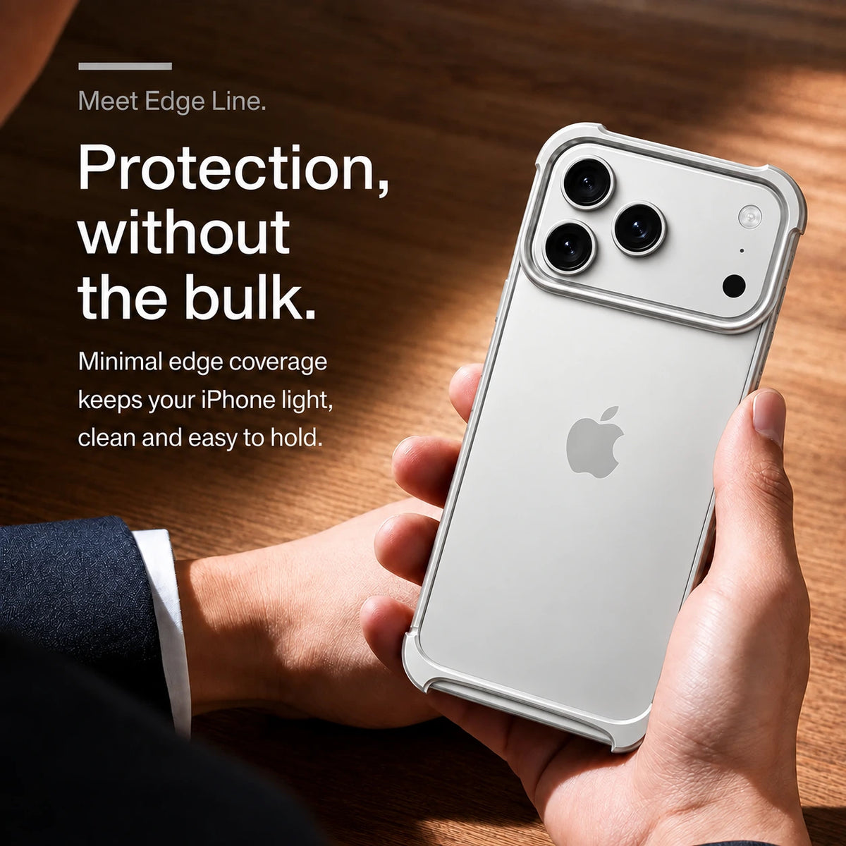Silver open metal bumper phone case held above a wooden desk #color_Titanium Silver