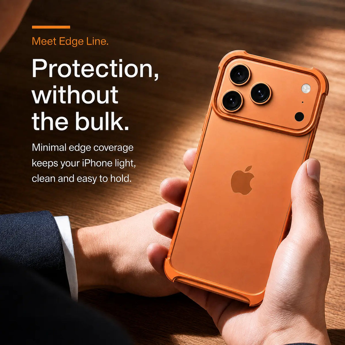 Orange open-back bumper phone case held beside a wooden table #color_Cosmic Orange